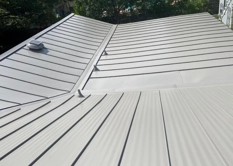 Solar attic fan installed on a metal roof for Roof Ventilation in Westtown